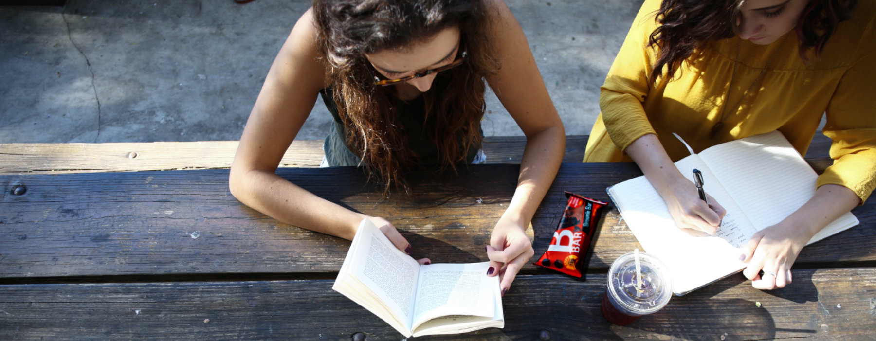 Girls reading books next a Bbar Brownie bar