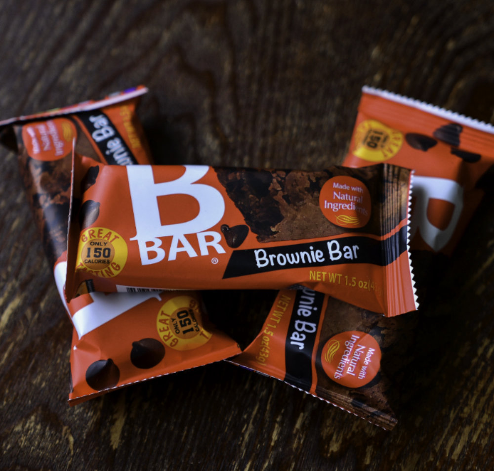 Man holding an opened Bbar Brownie bar